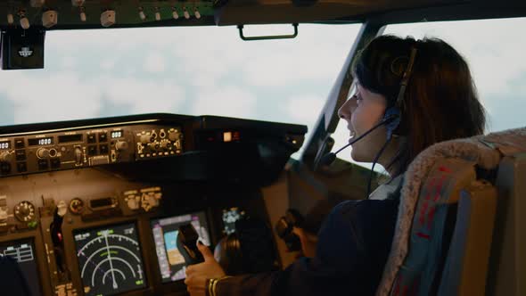 Woman Copilot Using Control Panel Command in Captain Cabin alt
