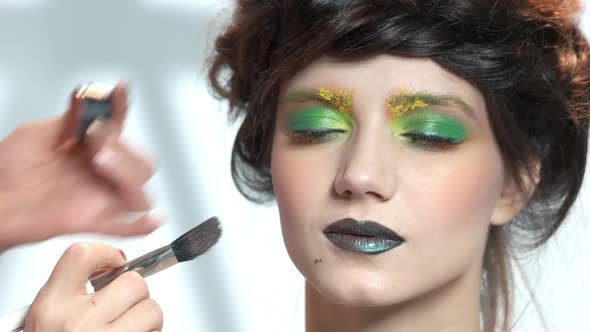 Hands of Makeup Artist Working. alt