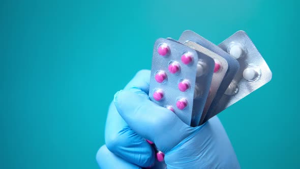 Close Up of Hand Holding Blister Packs  alt