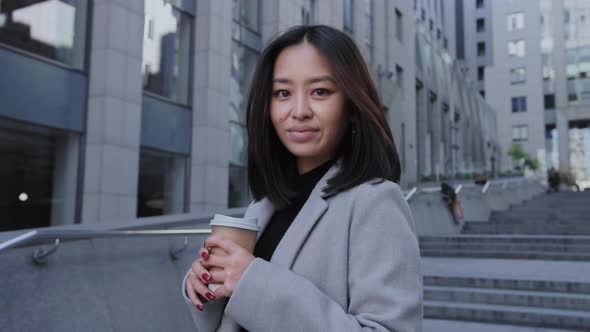 Young Adult Asian Woman Smiling and Looking at Camera in Slow Motion alt