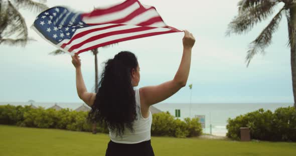 The Concept of Patriotism Independence Day and Holidays a Happy Smiling Young Woman in a Tshirt Runs alt