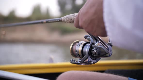 fishing rod in the hands of a man close-up