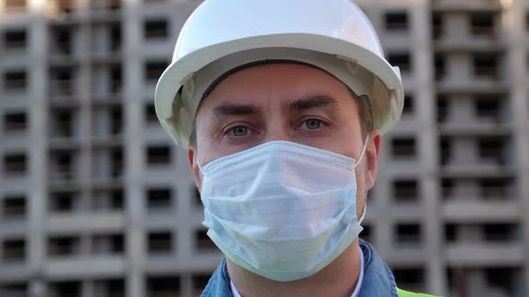 Engineer in Helmet and Medical Mask Protect Himself From Covid-19 During Coronavirus Epidemic alt