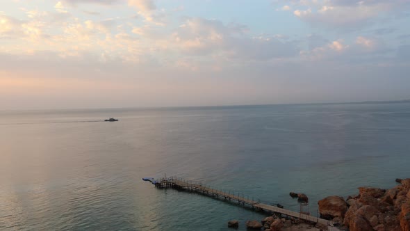 Aerial View to Calm Blue Sea Sandy Beach with Rocky Coastline