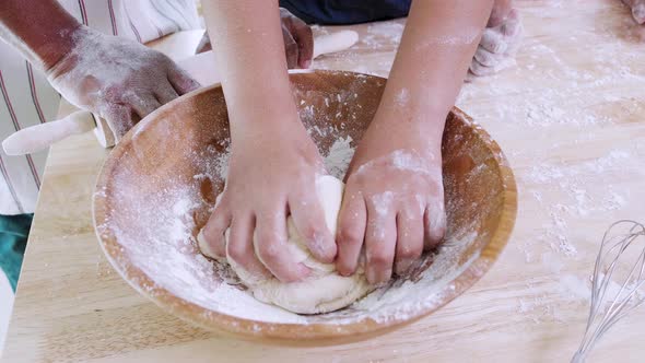 Close up of African American girl hand thresh dough at home in the kitchen