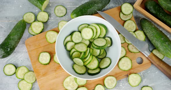 Cucumber Slices Fall Into the Bowl.  alt