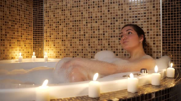 Beautiful Woman Taking a Bath By Candlelight alt