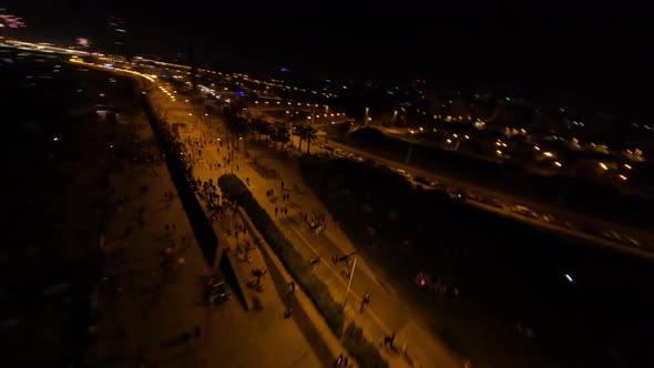 Night Fpv Drone Shot of Coastal Line During Fire Show Event