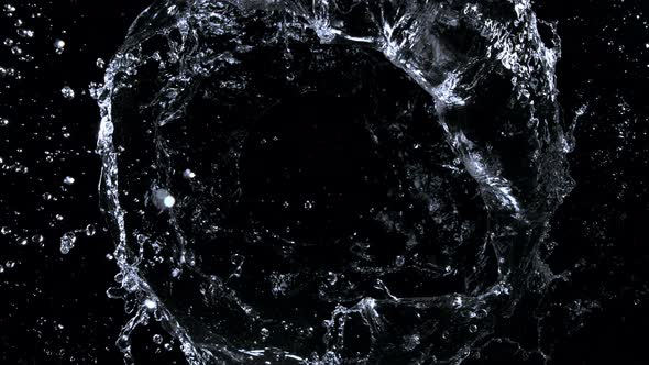 Super Slow Motion Shot of Rotating Water Ring Moving Towards Camera at 1000Fps alt