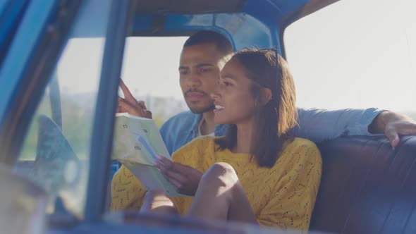 Young couple on a road trip in their pick-up truck alt