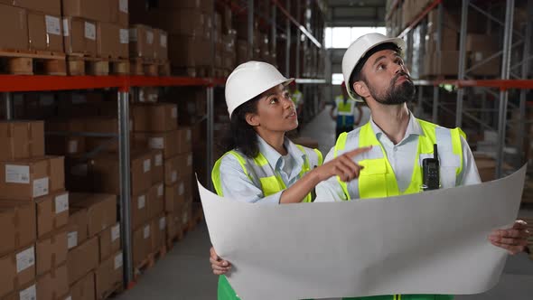 Logistics Managers Discussing Warehouse Plan alt