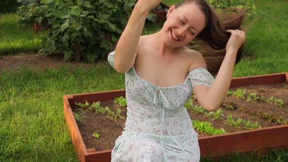 Charming Woman Sitting in Garden