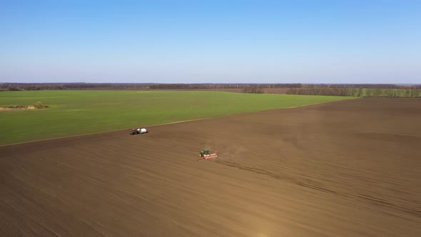 Aerial View of the Tractor Plowing Fields - Preparing Land for Sowing