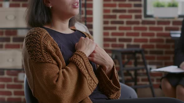 Close Up of Woman Crying and Sharing Story About Alcohol Addiction at Group Therapy alt