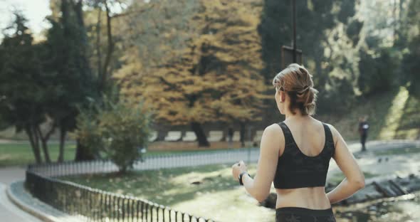 Sport fitness model in sporty running clothes with airpods headphones ear white hands free alt