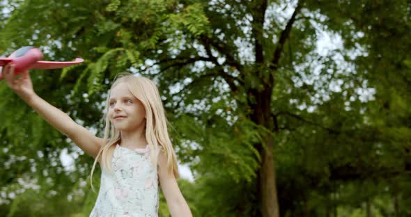 Little Child Play with a Toy Airplane Girl Wants to Become Pilot Dream Children alt