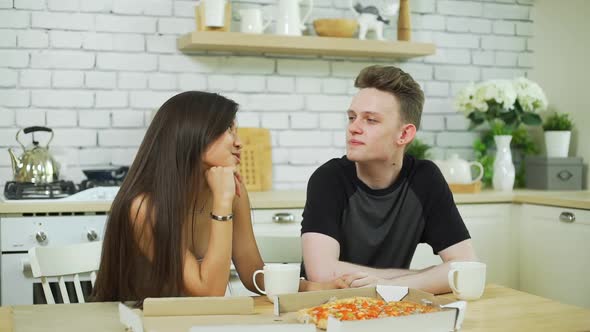 Smiling Teenage Couple Having Lunch in Kitchen alt