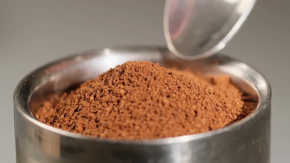 Spoon take freshly ground coffee. Brew smelling morning coffee. 