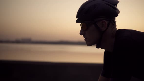 Sport Recreation Bike Cycling On Sunset Time. Cyclist In Helmet Riding On Sunset. Cardio Workout. alt