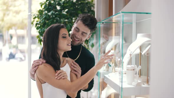 Man and Woman Choosing Jewelry in a Boutique Store alt