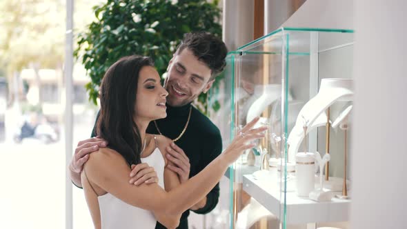 Man and Woman Choosing Jewelry in a Boutique Store