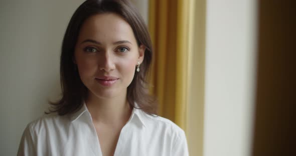 Portrait of Young Woman Looking Happy Indoors By Window Slow Motion Natural Light, Close Up  alt
