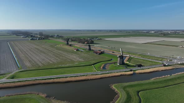 Historic Dutch Windmills in a Farm and Grass Field Landscape in The Netherlands Holland alt