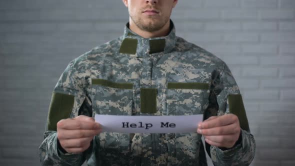 Help Me Word Written on Sign in Hands of Male Soldier, Medical Assistance alt