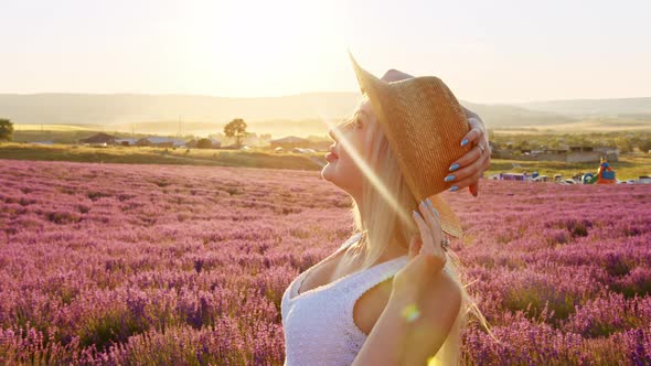 Portrait of a Blonde Woman with Hat in Lavender Fields on Summer