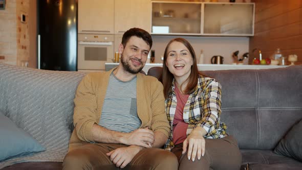 Portrait of Man and Woman Watching TV and Talking When Children Coming Closing Eyes Expressing Love alt