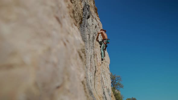 Young Powerful Athletic Man Rock Climber With Long Hair Climbing On Cliff Stock Footage