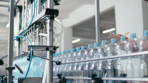 Water Bottles Moving on Automatic Conveyor Line in Water Production Factory