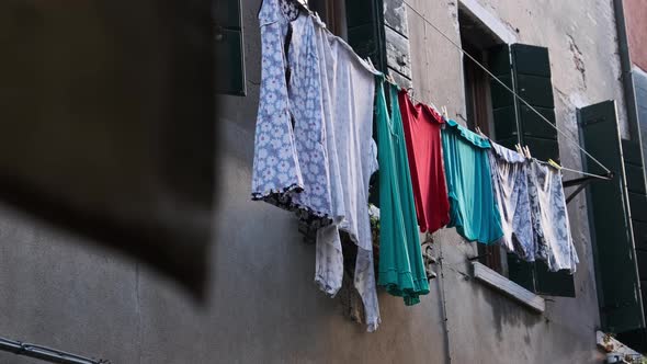 Laundry Dries on a Line Outside an Old Building on Venice Street Italy alt