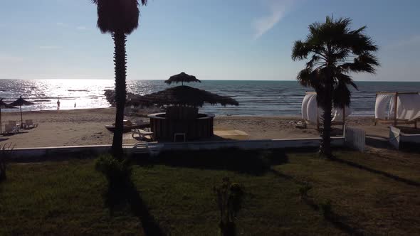 Aerial View to Durres Sandy Beach with Sun Beds and Umbrellas During Sunrise Early Morning alt
