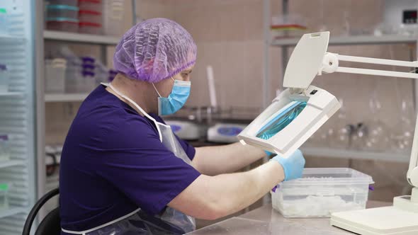 A Laboratory Worker Checks the Condition of the Samples Before Testing alt
