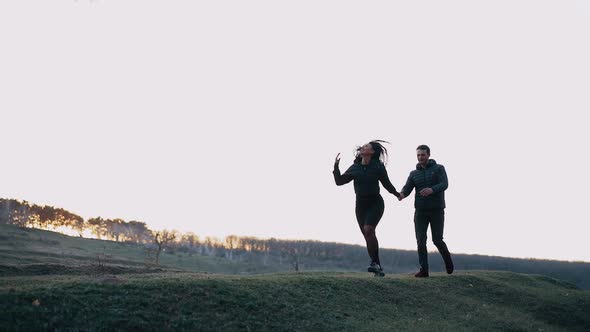 Wide Frame with a Mature Couple Who Walk Happily and Hold Hands Smiling
