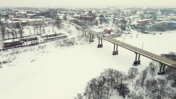 Beautiful Snowy Winter Landscape Aerial View Road Bridge and Frozen River alt