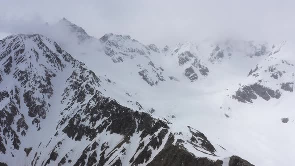 Flight above snowcapped mountains near Elbrus