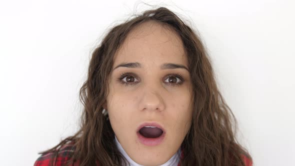 Portrait of Young Surprised and Shocked Brunette Woman on a White Background