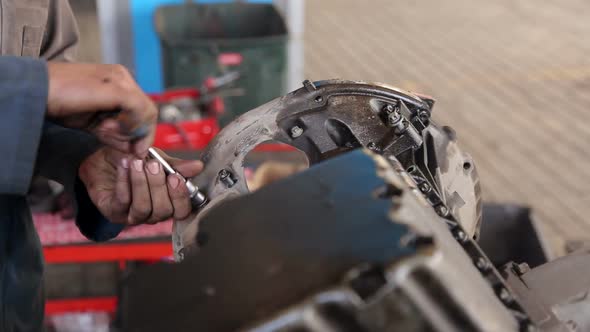 Close-up of the Mechanic's Hands, He Repairs the Engine in the Car
