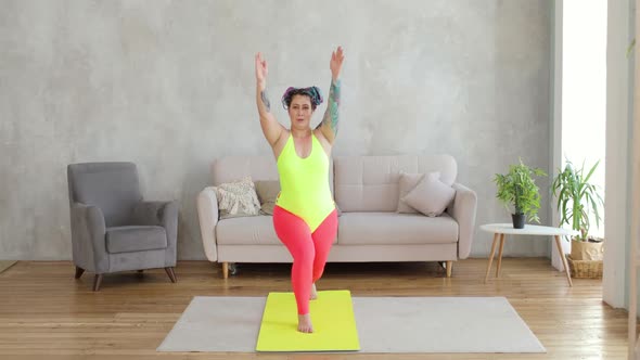Fat Woman Doing Squats in Lunges Exercise with Hands Up Standing on Mat at Home