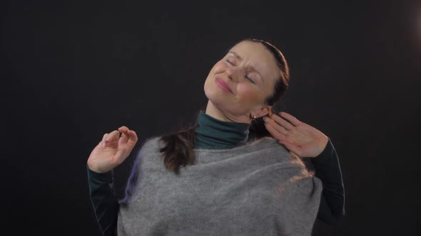 Pretty Woman with Long Dark Hair Holds Hands on Aching Head alt