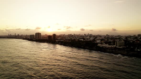 Aerial. Drone view on the sunset Santo Domingo city silhouette at the city and epic sun.