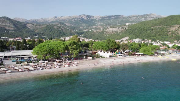 Aerial View Budva Beach By Sea with Sun Loungers and People Seashore Montenegro alt