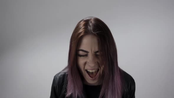 Portrait of the Girl Screaming Loud and Burying Her Hands in Her Hair Feeling Pain alt