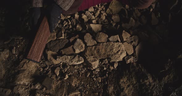 Gloved Hands Rolling Out Mat On Cave Floor alt