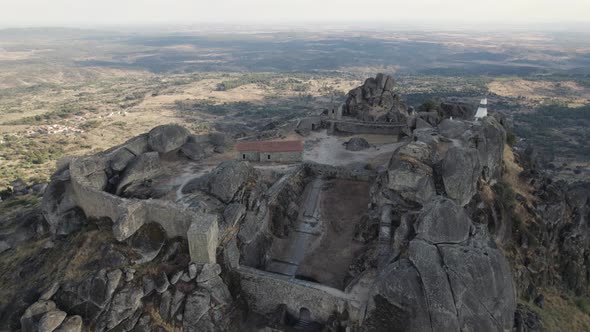 Wide aerial view picturesque castle on hilltop, Monsanto Rocky Landscape