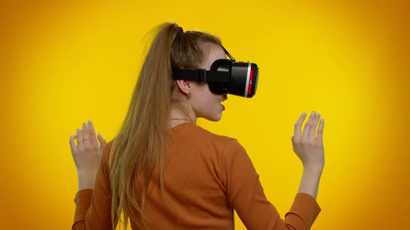 Girl Using Virtual Reality Futuristic Technology VR Headset Helmet to Play Simulation 3D Video Game alt
