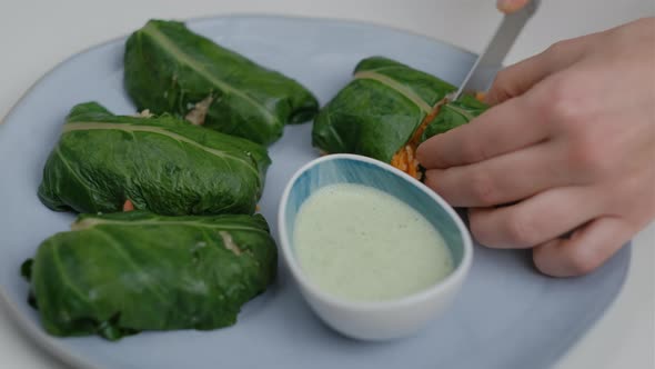 Close-up of veggie wrap with quinoa and vegetables on the blue plate and white table alt