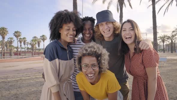 Young Friends Looking at Smiling Camera alt